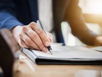 estate agent gives pen and documents agreement with customer to sign contract. Concept agreement